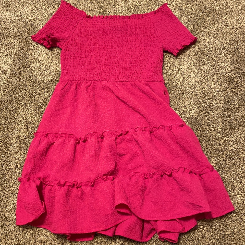 Hot pink ish dress with kind of a little bit of ruffles on the top it real cute